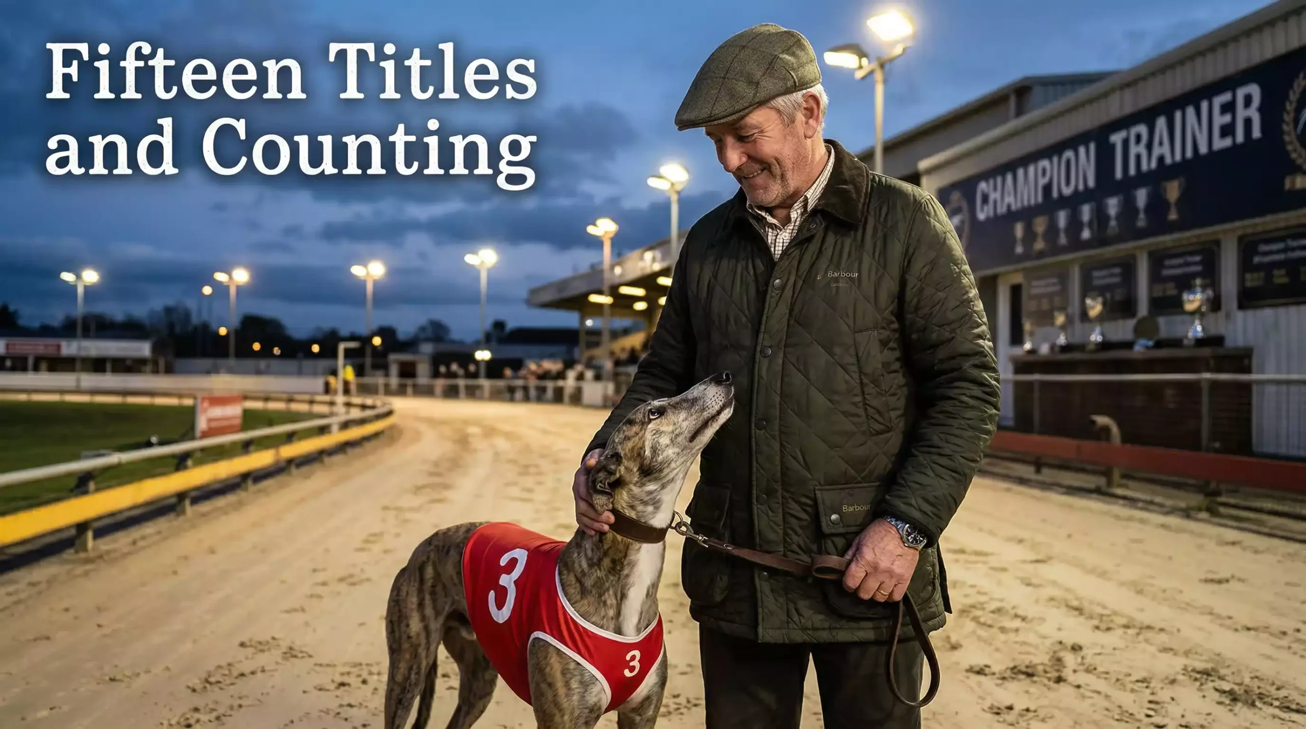Greyhound trainer in a flat cap standing with a racing dog on a floodlit track at dusk